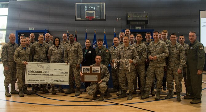 Airmen who submitted ideas to improve the 86th Airlift Wing during the Innovation Madness tournament showcase were presented a $250,000 check and the Lt. Gen. William H. Tunner Trophy May 1, 2015, at Ramstein Air Base, Germany. The inaugural competition started with nine wings from around USAFE-AFAFRICA competing with each other in a tournament-style match to determine which wing promotes the best innovative culture. (U.S. Air Force photo/Senior Airman Jonathan Stefanko)