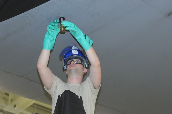 Senior Airman Daniel Clegg, crew chief for the 910th Aircraft Maintenance Squadron, attaches a fitting in preparation for draining a fuel tank on a C-130H Hercules aircraft here, May 2, 2015. The fuel tank is drained for maintainers to perform a fuel-quality check. (U.S. Air Force photo/ TSgt Rick Lisum)