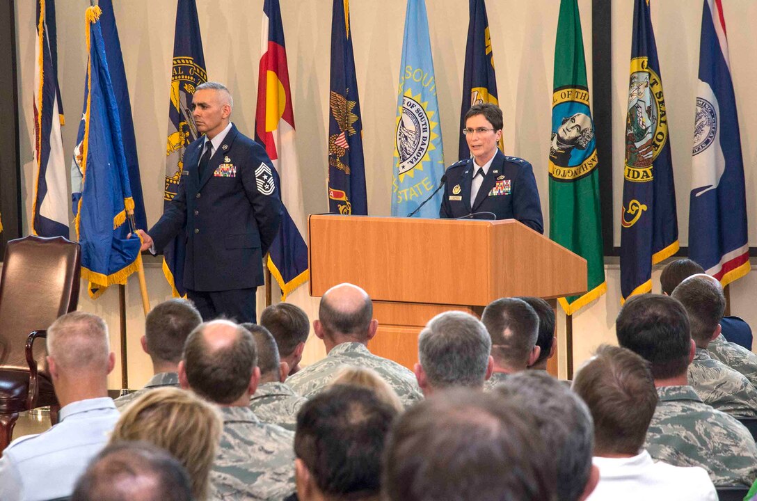 Maj. Gen. Theresa C. Carter, the Air Force Installation and Mission Support Center commander, speaks to those gathered during the activation ceremony of the new unit May 5, 2015, at Joint Base San Antonio-Lackland, Texas, while Chief Master Sgt. Jose LugoSantiago, AFIMSC's command chief master sergeant, stands nearby with the Air Force flag. (U.S. Air Force photo by Johnny Saldivar/released)
