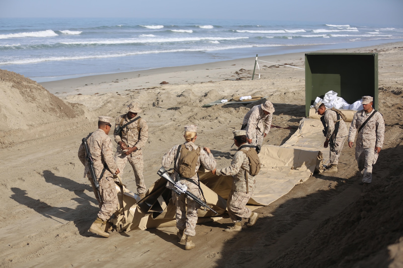 U.S. Marines with Bulk Fuel Company, 7th Engineer Support Battalion, 1st Marine Logistics Group,  roll out a berm liner on Camp Pendleton Calif., May 1, 2015. The berm liner is used as part of the Beach Unloading System used to house fuel which is pumped from a ship off shore. (U.S. Marine Corps Photo by Cpl. Rodion Zabolotniy, Combat Camera/Released)