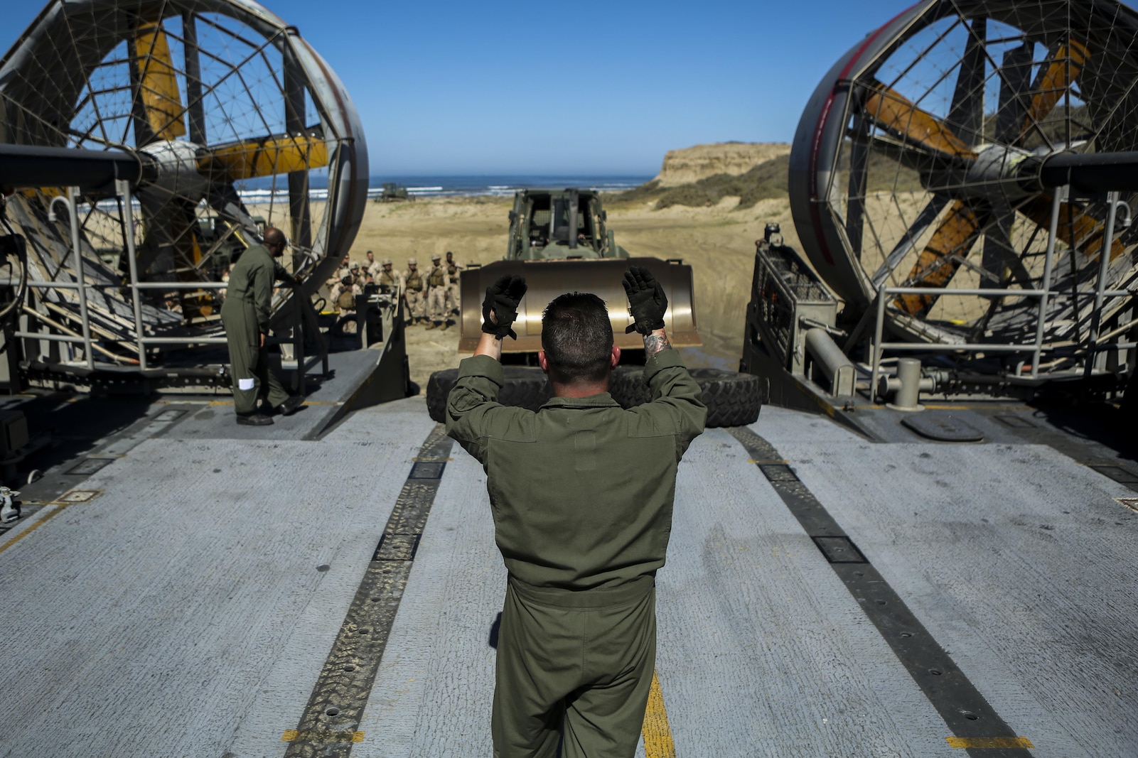 A U.S. Sailor with Assault Craft Unit 5 loads a U.S. Marine Humvee onto a Landing Craft Air Cushioned (LCAC) as part of an exercise along side Bulk Fuel Company, 7th Engineer Support Battalion aboard Camp Pendleton, Calif., April 27, 2015. This exercise reinforces the Marine Corps role as an amphibious force in readiness by maintaining capabilities through realistic training. (U.S. Marine Corps photo by Lance Cpl. Lauren Falk/Released)