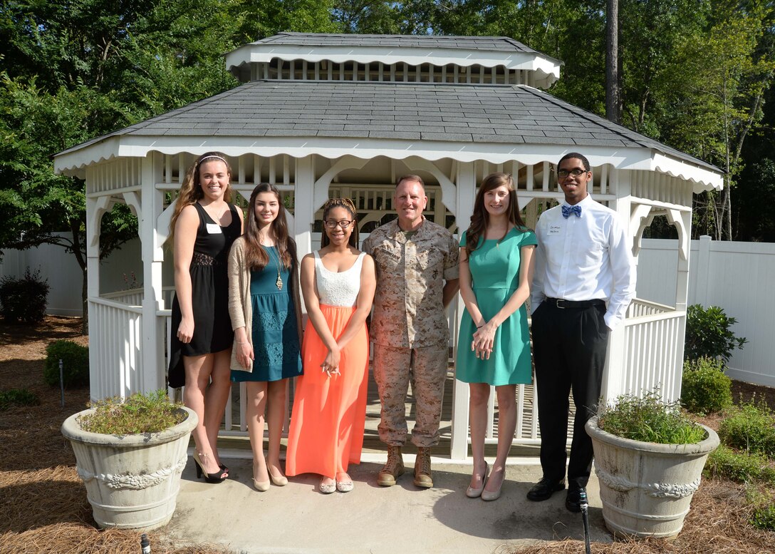The Officers Spouses’ Club at Marine Corps Logistics Base Albany awards five college scholarships to graduating seniors and three grants to community organizations at their Community Enrichment and Scholarship Award Reception, here, May 5. Flanked by the candidates, Maj. Gen. John J. Broadmeadow, commanding general, Marine Corps Logistics Command, and his wife, Karen, hosted this year’s annual event.