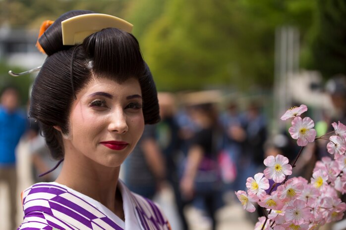 Cpl. Jessica Quezada, the operations chief with the Public Affairs Office aboard Marine Corps Air Station Iwakuni, Japan, poses for a photo before the Daimyo Procession during the 38th Annual Kintai-kyo Bridge Festival, in Iwakuni City, April 29, 2015. The procession is an annual parade that reenacts the return of a daimyo, one of the most powerful feudal rulers who is subordinate only to the shogun and his entourage from the capital of Japan.
