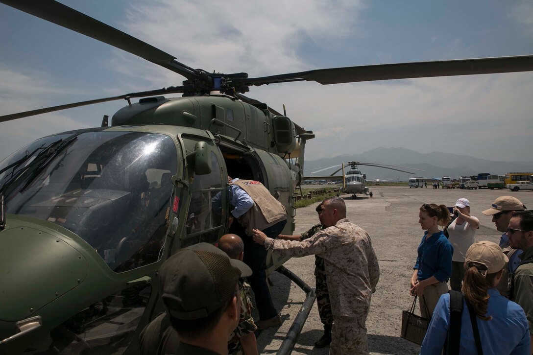 Lt. Gen. John E. Wissler and members of the United States Agency of International Development prepare to depart to village Bhirkuna Deurali, Nepal, May 5 at Tribhuvan international airport. Wissler and USAID members distribute supplies including tarps, sleeping systems and water purification solution. The Nepalese Government requested the U.S. Government’s help after the earthquake. USAID is a U.S. Government agency that gives civilian foreign aid in time of natural disasters. Wissler is the commanding general of III Marine Expeditionary Force.