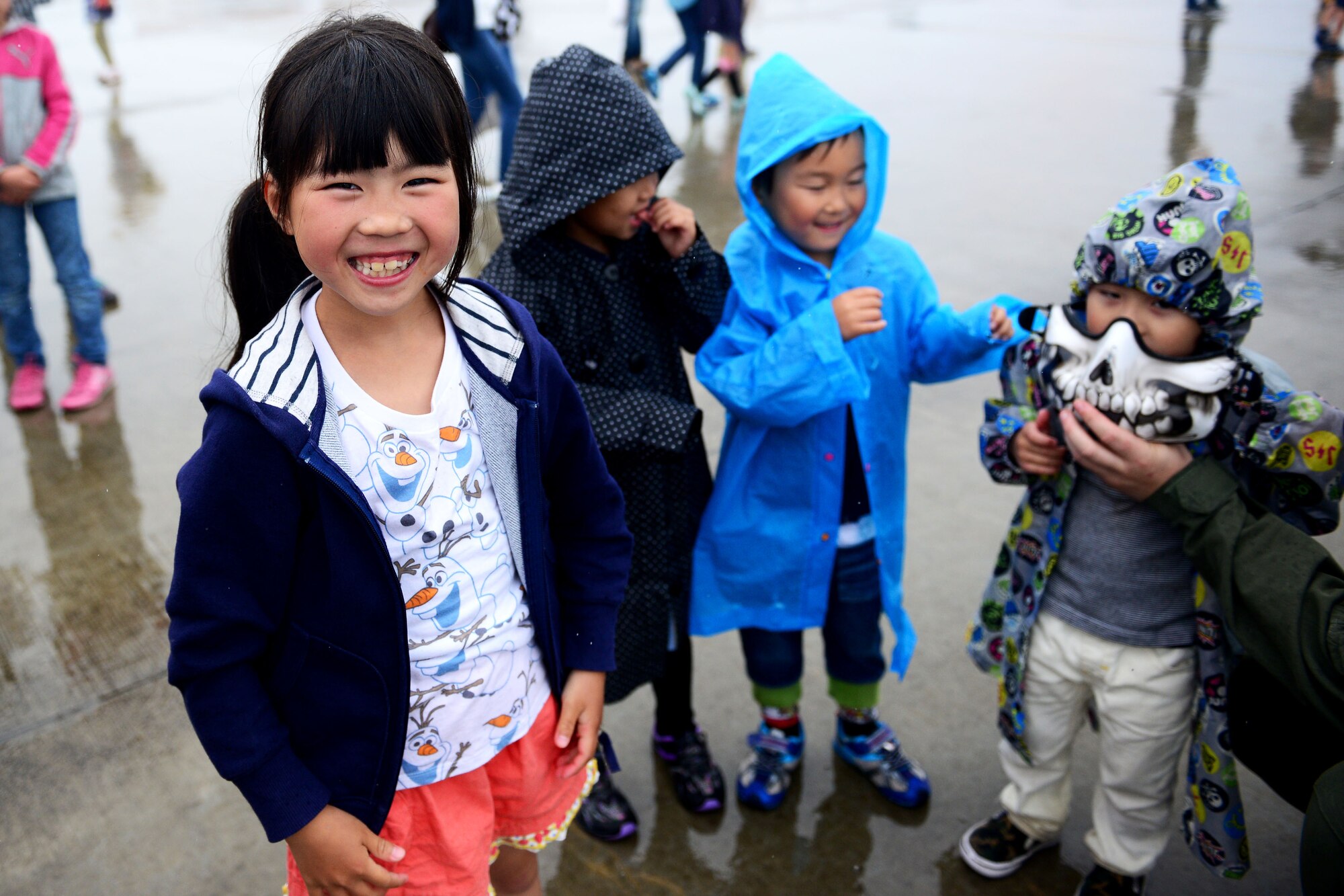 A local girl poses for a photo during the first-ever joint Friendship day Air Show hosted by Marine Corps Air Station Iwakuni, Japan, and Japan Maritime Self-Defense Force at MCAS Iwakuni, Japan, May 3, 2015. The event allowed visitors the chance to see several aircraft demonstrations and to interact with Japanese and American service members. (U.S. Air Force photo by Tech Sgt. Melissa K. Mekpongsatorn/Released)