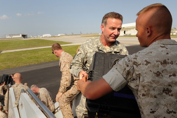 U.S. Army Col. Charlie Jenks, 351st Civil Affairs Command civil affairs planning team lead, hands a trunk to U.S. Marine Corps Private 1st Class Austin Cunningham, 3rd Transportation Spot Battalion landing support specialist, while loading cargo onto a U.S. Air Force KC-135 Stratotanker on Kadena Air Base, Japan, May 6, 2015. A joint team of Marines, soldiers and Airmen loaded the jet before travelling to Nepal together in support of the Department of Defense’s humanitarian efforts following the 7.8 magnitude earthquake there April 25. (U.S. Air Force photo by Airman 1st Class Zade C. Vadnais)