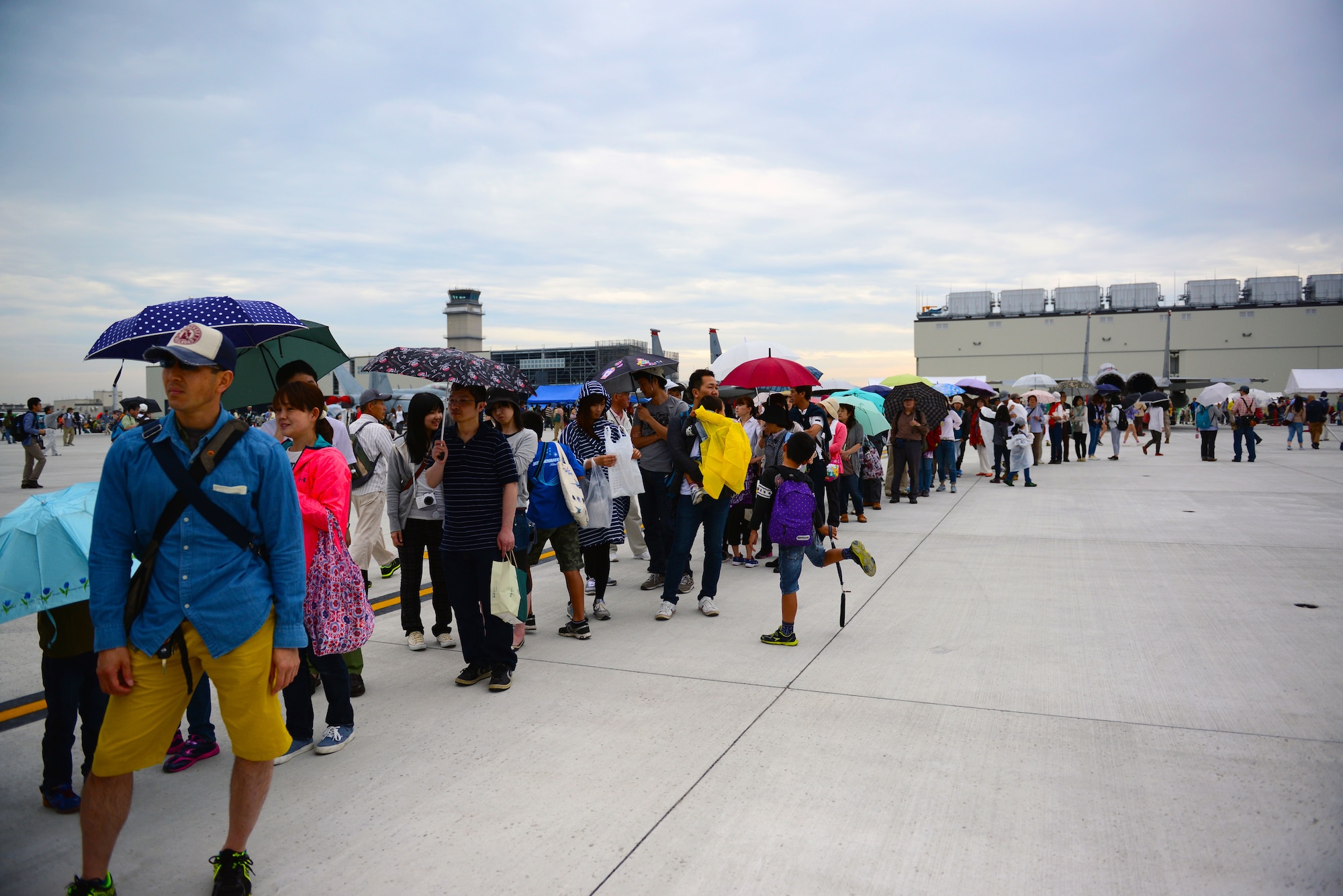 People form a line to get a glance inside a C-12 Huron during the Japan Maritime Self-Defense Force/Marine Corps Air Station Iwakuni Friendship Day 2015 Air Show at MCAS Iwakuni, Japan, May 3, 2015. MCAS Iwakuni and Japan Maritime Self-Defense Force hosted it's first-ever joint Friendship Day 2015 Air Show. Members with the 459th Airlift Squadron from Yokota Air Base, Japan, brought a UH-1N and a C-12 to the airshow to showcase their airlift capabilities to visitors. (U.S. Air Force photo by Tech Sgt. Melissa K. Mekpongsatorn/Released)