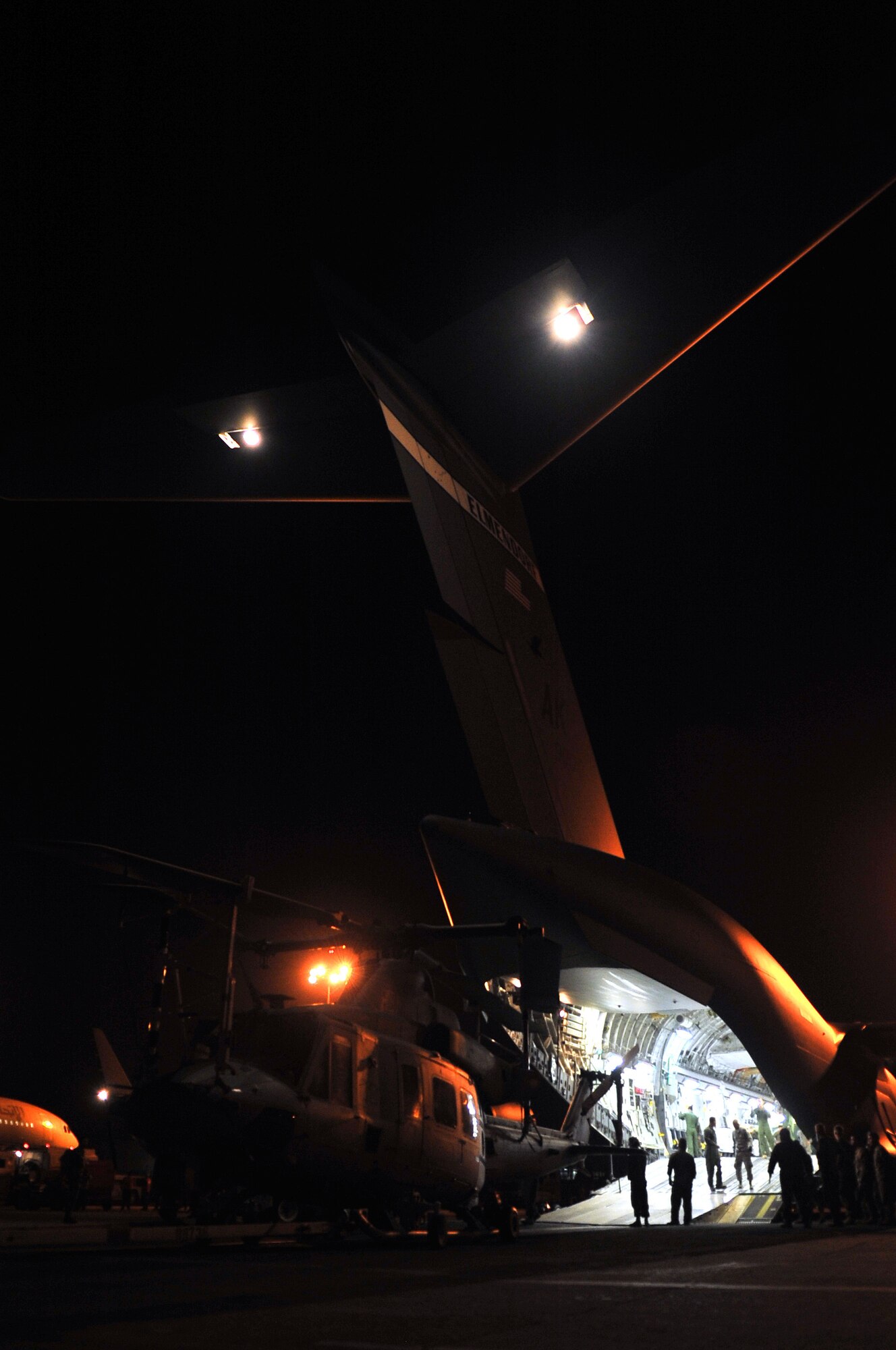 Airmen from the 36th Contingency Response Group and U.S. Marines unload a U.S. Marine UH-1Y Huey helicopter from a U.S. Air Force C-17 Globemaster III, at Tribhuvan International Airport, May 5, 2015. The 36th CRG is a rapid-deployment unit designed to establish and maintain airfield operations in a forward operating location and joined U.S. Department of State and U.S. Agency for International Development led humanitarian assistance and disaster relief operations in support of the government and armed forces of Nepal. (U.S. Air Force photo by Staff Sgt. Melissa White/Released)