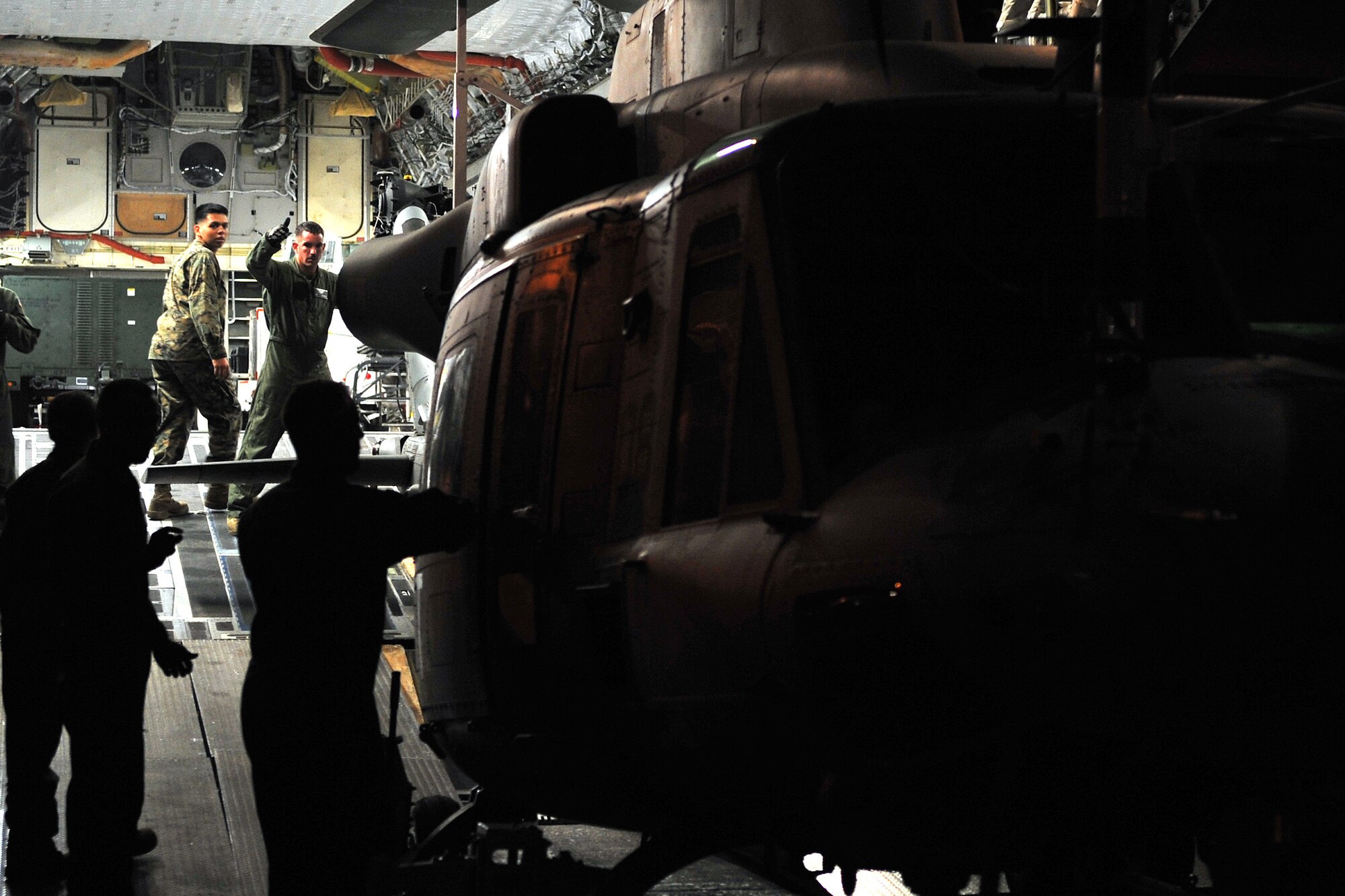 Airmen from the 36th Contingency Response Group and U.S. Marines unload a U.S. Marine UH-1Y Huey helicopter from a U.S. Air Force C-17 Globemaster III, at Tribhuvan International Airport, May 5, 2015. The 36th CRG is a rapid-deployment unit designed to establish and maintain airfield operations in a forward operating location and joined U.S. Department of State and U.S. Agency for International Development led humanitarian assistance and disaster relief operations in support of the government and armed forces of Nepal. (U.S. Air Force photo by Staff Sgt. Melissa White/Released)