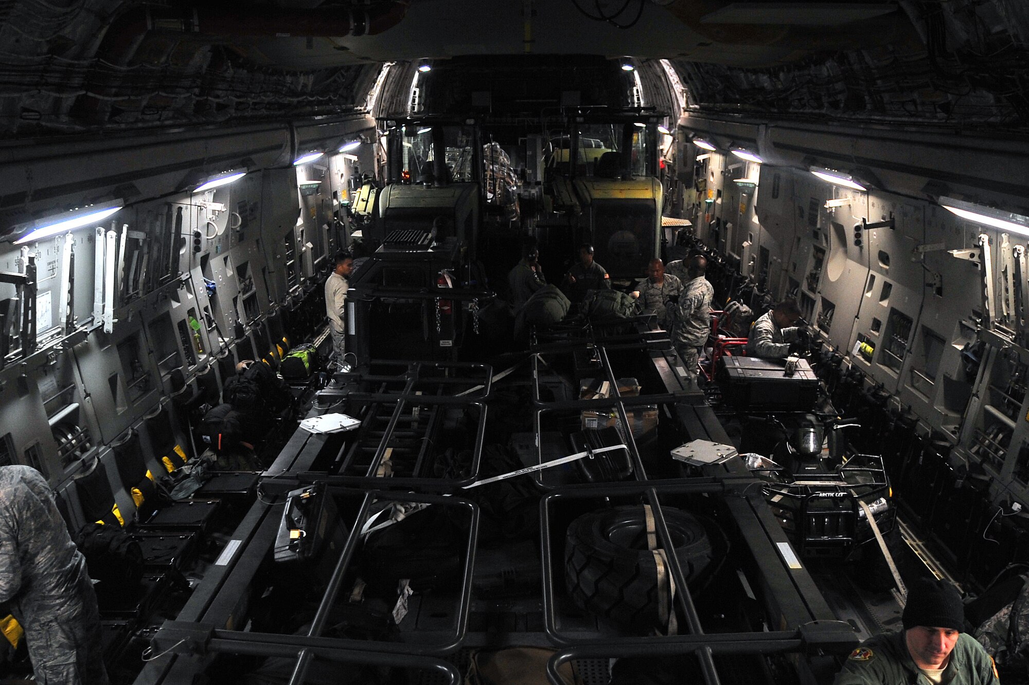 Airmen from the 36th Contingency Response Group prepare to unload cargo from a U.S. Air Force C-17 Globemaster III, at Tribhuvan International Airport, Nepal, May 5, 2015. The 36th CRG is a rapid-deployment unit designed to establish and maintain airfield operations in a forward operating location and joined U.S. Department of State and U.S. Agency for International Development led humanitarian assistance and disaster relief operations in support of the government and armed forces of Nepal. (U.S. Air Force photo by Staff Sgt. Melissa White/Released)
