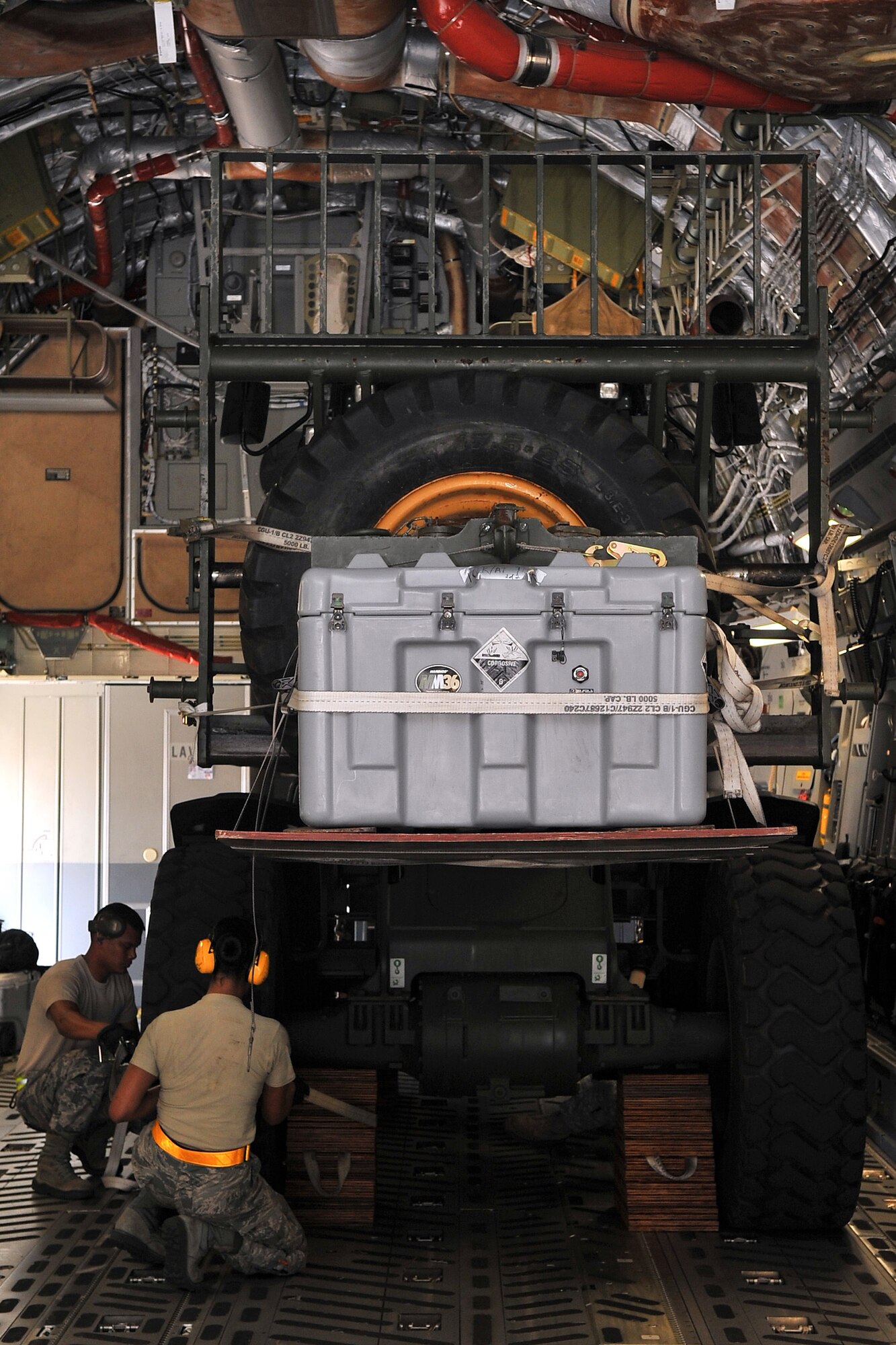 Airman 1st Class Andrew Mad (left) and Senior Airman Geralynn Lunod (right), both 734th Air Mobility Squadron air transportation specialists, secure a forklift inside a C-17 Globemaster III May 4, 2015, at Andersen Air Force Base, Guam, in preparation for deployment to Nepal. The 36th Contingency Response Group is a rapid-deployment unit designed to establish and maintain airfield operations in a forward operating location and is prepared to assist with the Nepal earthquake recovery efforts. (U.S. Air Force photo by Staff Sgt. Melissa B. White/Released)