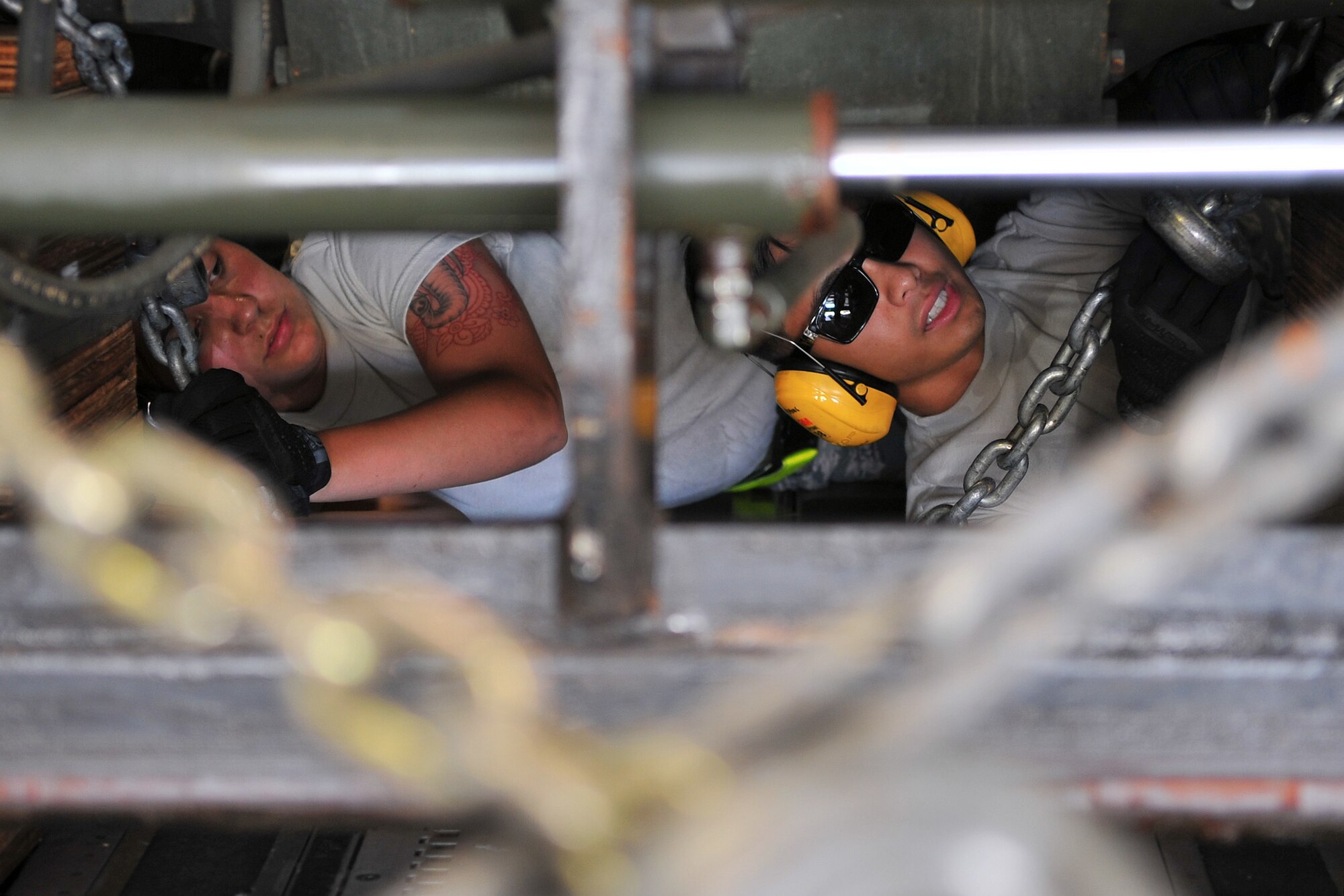 Airman 1st Class Courtney Wheeler (left) and Senior Airman Jordan Mafnas (right), both 734th Air Mobility Squadron air transportation specialists, secure a forklift inside a C-17 Globemaster III May 4, 2015, at Andersen Air Force Base, Guam, in preparation for deployment to Nepal. The 36th Contingency Response Group is a rapid-deployment unit designed to establish and maintain airfield operations in a forward operating location and is prepared to assist with the Nepal earthquake recovery efforts. (U.S. Air Force photo by Staff Sgt. Melissa B. White/Released)