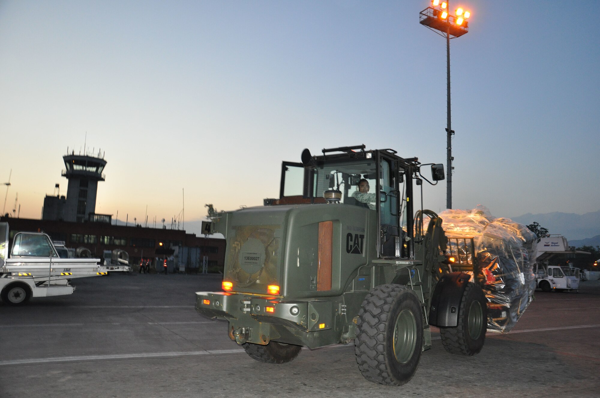 A U.S. Airman from the 36th Contingency Response Group moves palletized cargo using a forklift at Tribhuvan International Airport, Nepal, May 4, 2015. The CRG joined U.S. Department of State and U.S. Agency for International Development led humanitarian and disaster relief operations in support of the government and armed forces of Nepal. (U.S. Air Force photo by Maj. Ashley Conner/Released)