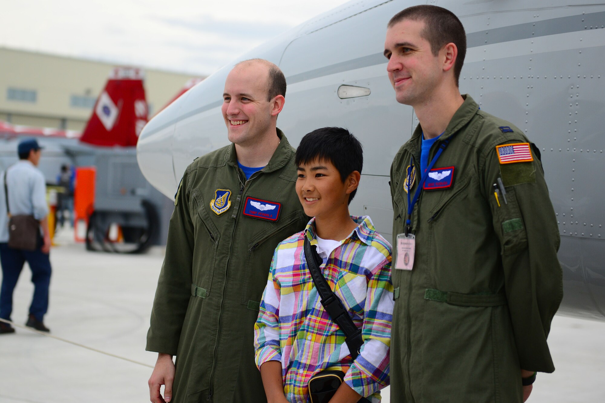1st Lt. Anthony Pergola (left) and Capt. Michael Farrara, 459th Airlift Squadron pilots, pose with a local boy during the Japan Maritime Self-Defense Force/Marine Corps Air Station Iwakuni Friendship Day 2015 Air Show at MCAS Iwakuni, Japan, May 3, 2015. The event allowed visitors the chance to see several aircraft demonstrations and to interact with Japanese and American service members. (U.S. Air Force photo by Tech Sgt. Melissa K. Mekpongsatorn/Released)


