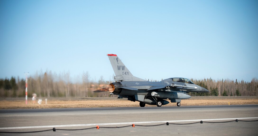A U.S. Air Force F-16 Fighting Falcon aircraft assigned to the 13th Fighter Squadron, Misawa Air Base, Japan, launches down the runway May 6, 2015, during RED FLAG-Alaska 15-2 at Eielson Air Force Base, Alaska. The two-week long exercise takes place within the Joint Pacific Alaska Range Complex, a 67,000 square-mile training range. (U.S. Air Force photo by Staff Sgt. Shawn Nickel/Released)