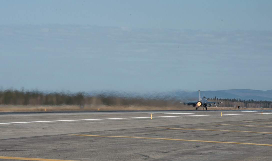 A U.S. Air Force F-16 Fighting Falcon aircraft assigned to the 13th Fighter Squadron, Misawa Air Base, Japan, launches down the runway May 6, 2015, during RED FLAG-Alaska 15-2 at Eielson Air Force Base, Alaska. The two-week long exercise takes place within the Joint Pacific Alaska Range Complex, a 67,000 square-mile training range. (U.S. Air Force photo by Staff Sgt. Shawn Nickel/Released)