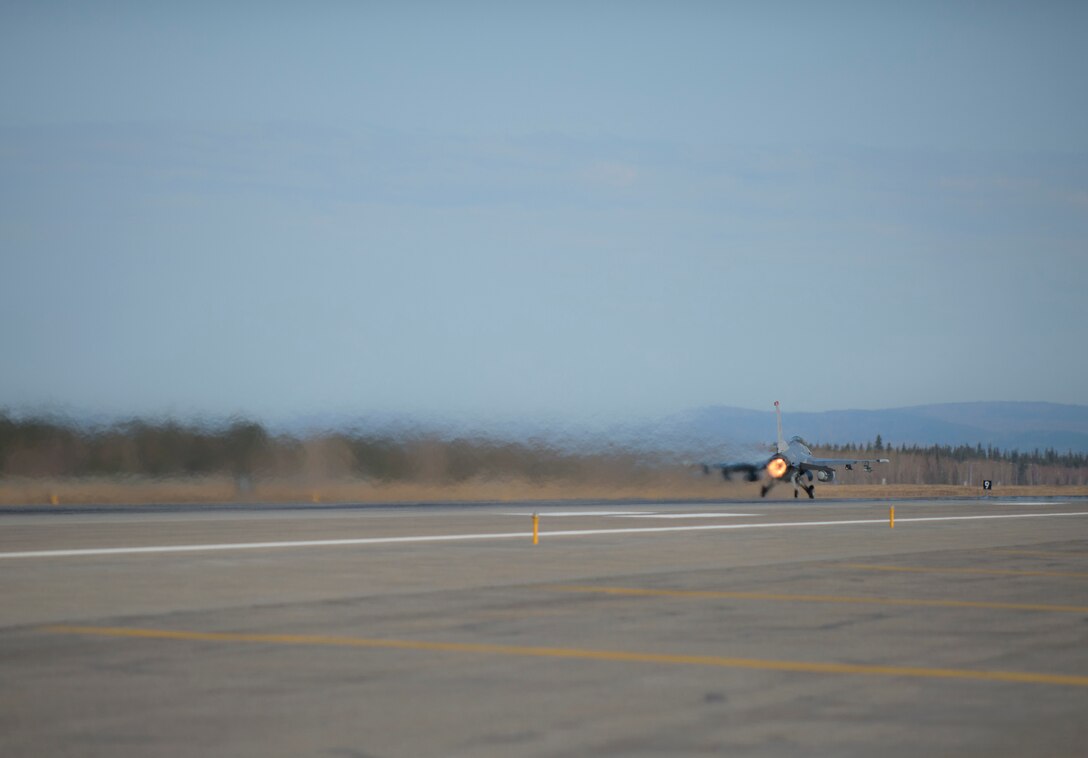 A U.S. Air Force F-16 Fighting Falcon aircraft assigned to the 13th Fighter Squadron, Misawa Air Base, Japan, launches down the Eielson Air Force Base, Alaska, runway May 6, 2015, during RED FLAG-Alaska 15-2. The two-week long exercise takes place within the Joint Pacific Alaska Range Complex, a 67,000 square-mile training range. (U.S. Air Force photo by Staff Sgt. Shawn Nickel/Released)