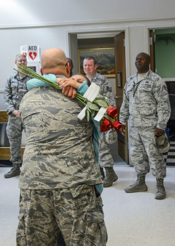 Airmen from the 31st Test and Evaluation Squadron watch as Araceli hugs her husband for the first time in six months. (U.S. Air Force photo by Rebecca Amber)