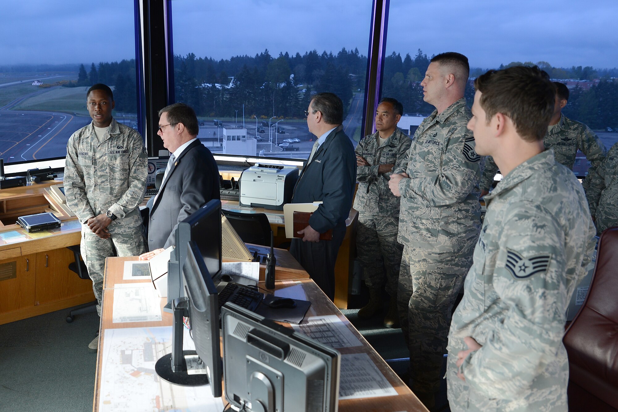 Senior Airman David Douglas (left), 62nd Operations Support Squadron air traffic controller, briefs Congressman Denny Heck, WA-10, on operations in the McChord tower May 6, 2015, at Joint Base Lewis-McChord, Wash. The brief was intended to give Heck a clear understanding on how McChord Field manages air traffic. (U.S.  Air Force photo \ Staff Sgt. Tim Chacon)