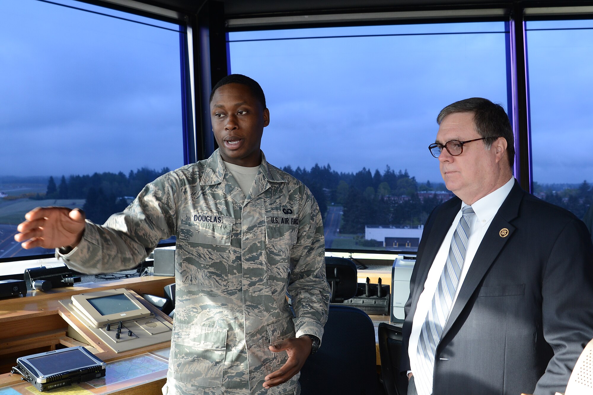 Senior Airman David Douglas, 62nd Operations Support Squadron air traffic controller, briefs Congressman Denny Heck, WA-10, on operations in the McChord tower May 6, 2015, at Joint Base Lewis-McChord, Wash. The brief was intended to give Heck a clear understanding on how McChord Field manages air traffic. (U.S.  Air Force photo \ Staff Sgt. Tim Chacon)