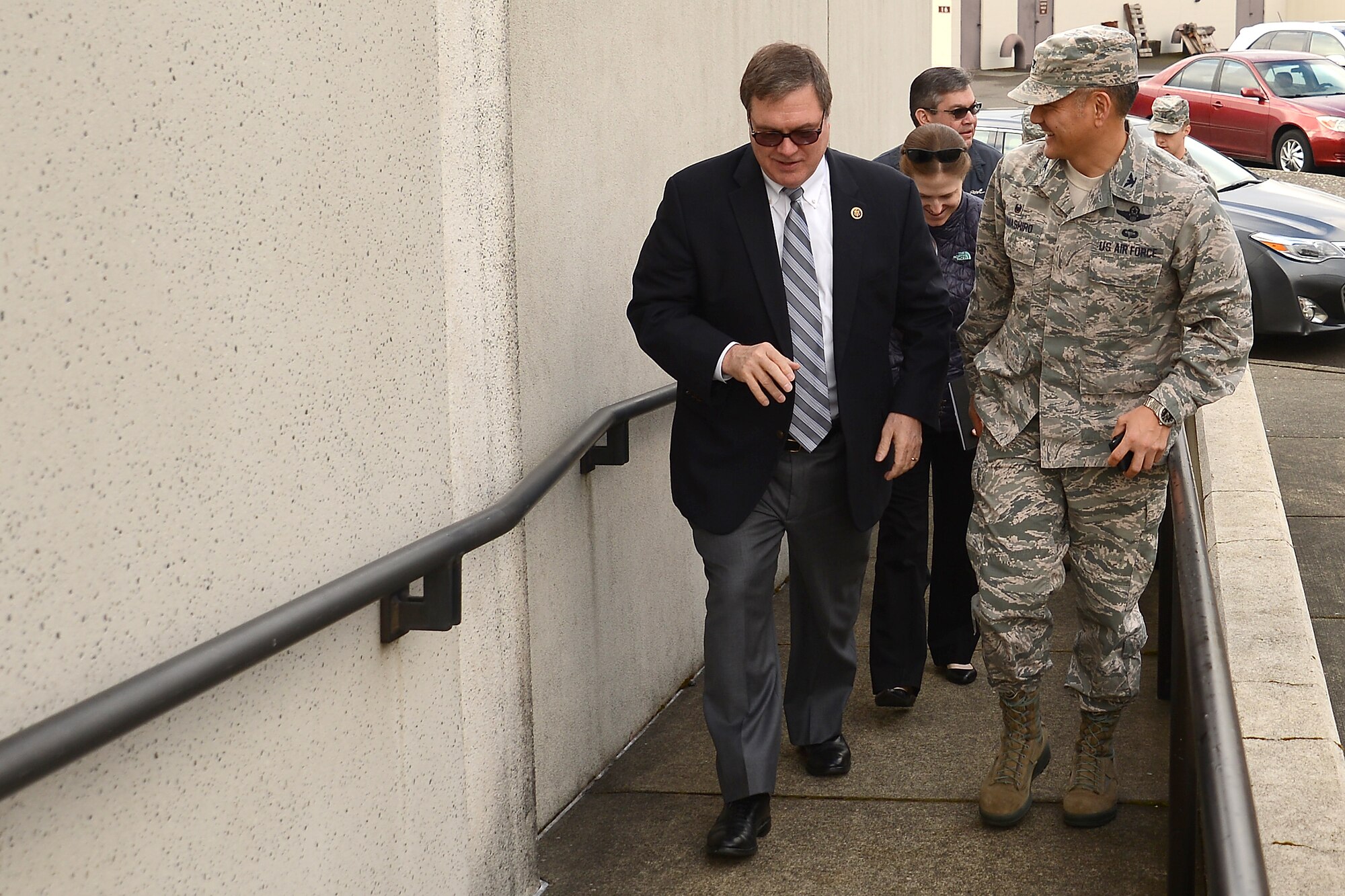 Col. David Kumashiro (right), 62nd Airlift Wing commander, walks with Congressman Denny Heck, WA-10, to the McChord tower May 6, 2015, at Joint Base Lewis-McChord, Wash. The tower was one stop of many across JBLM for Heck as part of a community update brief. (U.S.  Air Force photo \ Staff Sgt. Tim Chacon)