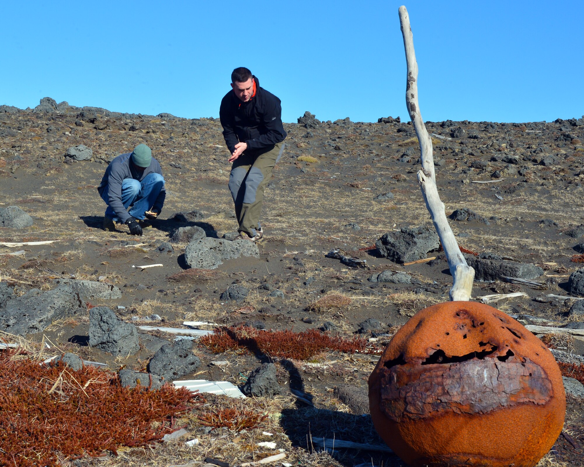 U.S. Air Force Tech. Sgt. Tyrone Garner and U.S. Air Force Maj. Christopher Howell of the 871st Air Expeditionary Squadron search for trash during a beach clean-up on the Reykjanes Peninsula, Iceland, May 2, 2015. Airmen who deployed to Iceland for Icelandic Air Surveillance and Policing and members of the Icelandic environmental organization the Blue Army spent four hours clearing the beach of man-made debris for the service project. (U.S. Air Force photo by 2nd Lt Meredith Mulvihill/Released)