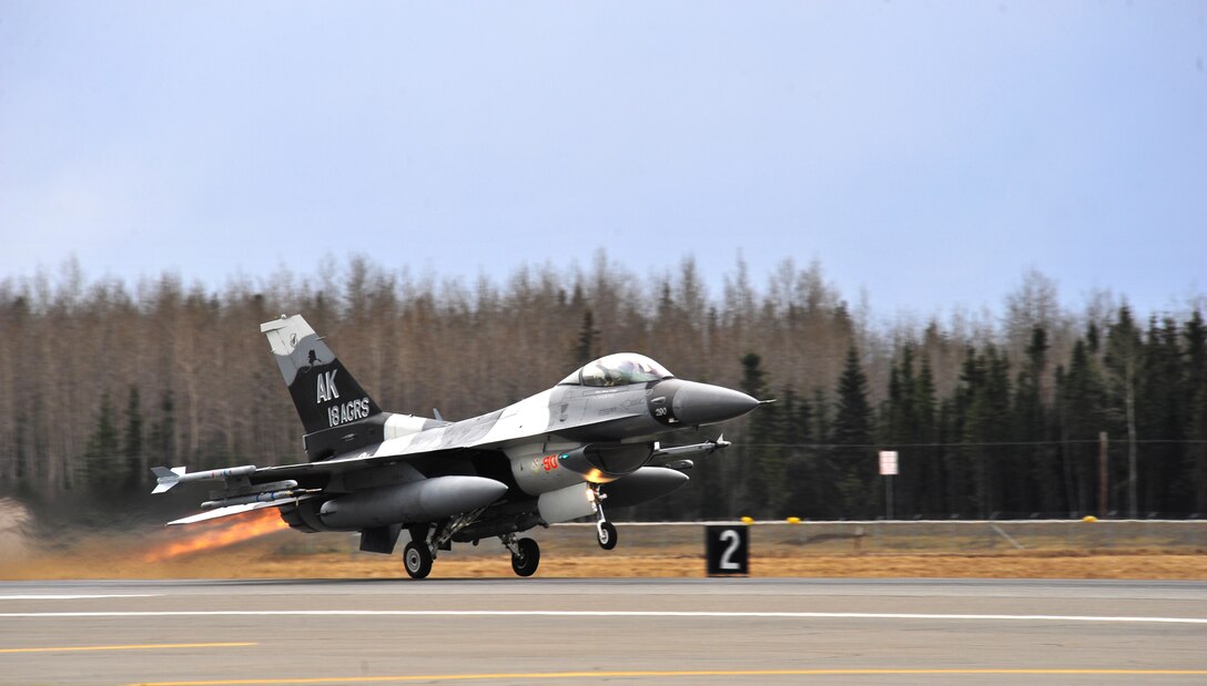 A U.S. Air Force F-16 Fighting Falcon aircraft assigned to the 18th Aggressor Squadron launches from the runway May 5, 2015, during a RED FLAG-Alaska (RF-A) 15-2 mission at Eielson Air Force Base, Alaska.  Aggressor pilots are trained to act as opposing forces in exercises like RF-A to better prepare U.S. and allied forces for aerial combat. (U.S. Air Force photo by Tech. Sgt. Miguel Lara III/Released)