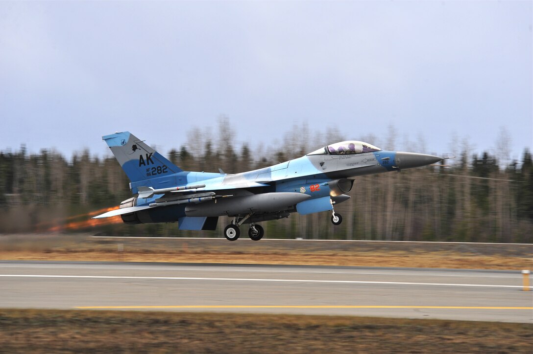 A U.S. Air Force F-16 Fighting Falcon aircraft assigned to the 18th Aggressor Squadron launches from the runway May 5, 2015, during a RED FLAG-Alaska (RF-A) 15-2 mission at Eielson Air Force Base, Alaska.  Aggressor pilots are trained to act as opposing forces in exercises like RF-A to better prepare U.S. and allied forces for aerial combat. (U.S. Air Force photo by Tech. Sgt. Miguel Lara III/Released)