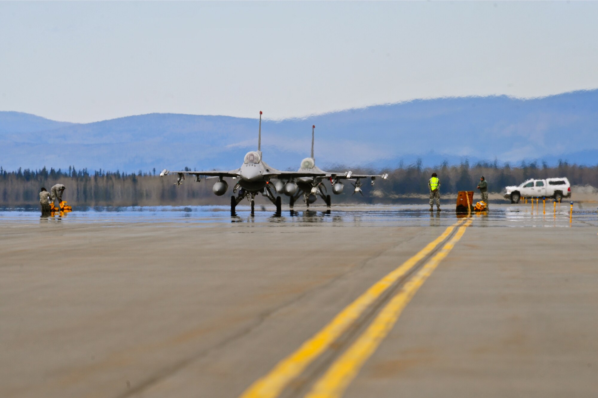 A pair of U.S. Air Force F-16 Fighting Falcon aircraft assigned to the 13th Fighter Squadron, Misawa Air Base, Japan, taxi the runway May 5, 2015, prior to a RED FLAG-Alaska (RF-A) 15-2 mission at Eielson Air Force Base, Alaska.  RF-A exercises are vital to maintaining peace and stability in the Asia-Pacific region. (U.S. Air Force photo by Tech. Sgt. Miguel Lara III/Released)