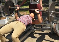 Senior Airman Whitney Lawson, 403rd Wing photojournalist, participates in the bench press contest May 2, 2015, during the 403rd Wing Airman and Family Day at Keesler Air Force Base, Mississippi. (U.S. Air Force Photo/Staff Sgt. Nicholas Monteleone)