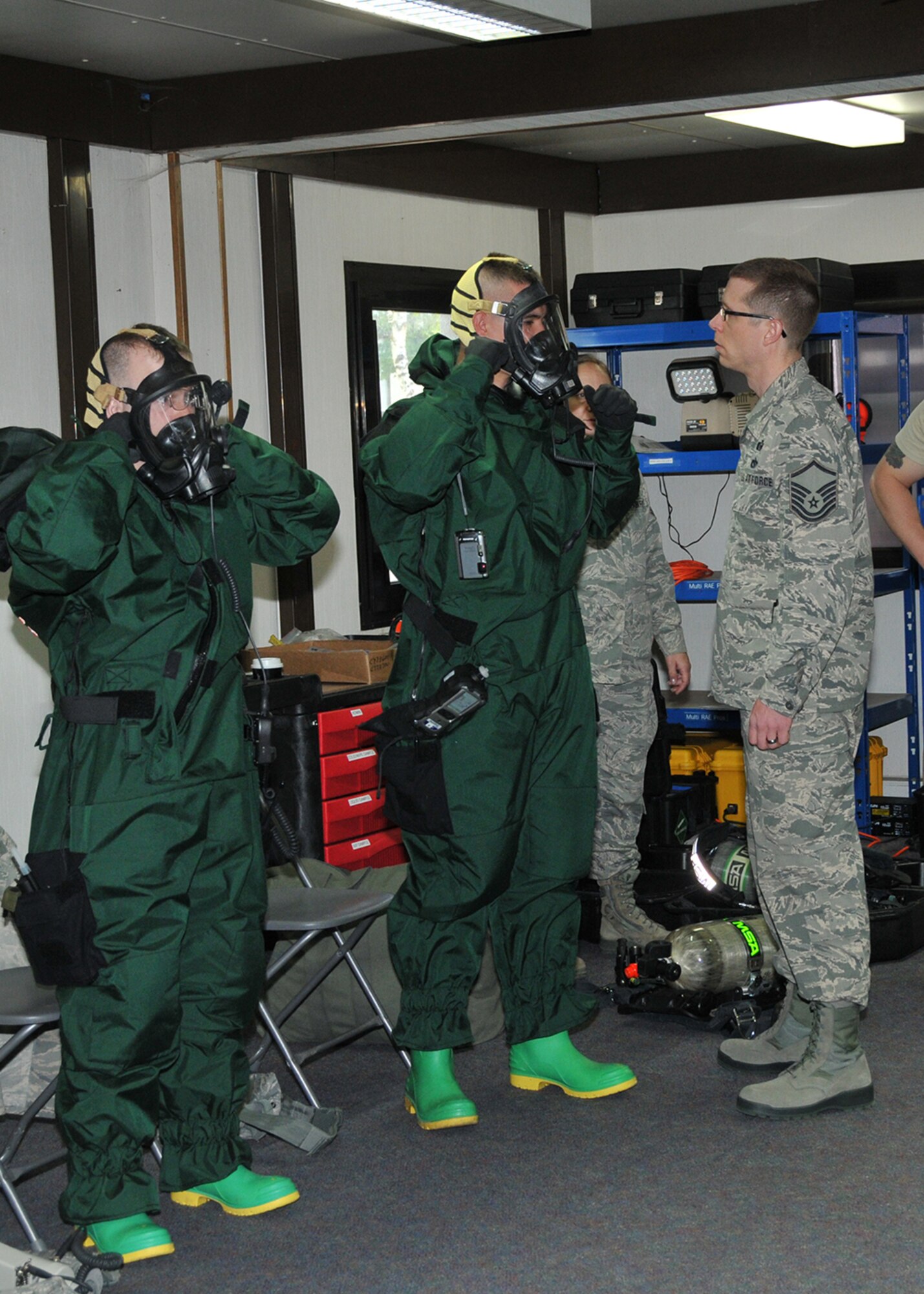 Master Sgt. Christopher McCrary, Emergency Management Flight non-commissioned officer in charge, Barnes Air National Guard Base, Westfield, Mass., inspects Airman 1st Class Neal Colburn and active-duty Staff Sgt. John Gaylord in their Personal Protection Level-B suits during an exercise May 6, 2015, Spangdahlem Air Base, Germany. The Guard and active-duty Airmen are training together on Active CBRNE (Chemical Biological Radiological Nuclear and High- Yield Explosives) Response to enhance their Hazmat Technician Certification. This is a required training that needs to be done by the guard and the active duty. Doing the training together allows them to increase their knowledge by sharing their experiences and use different types of equipment. (U.S. Air National Guard photo by Tech. Sgt. Melanie J. Casineau/Released)