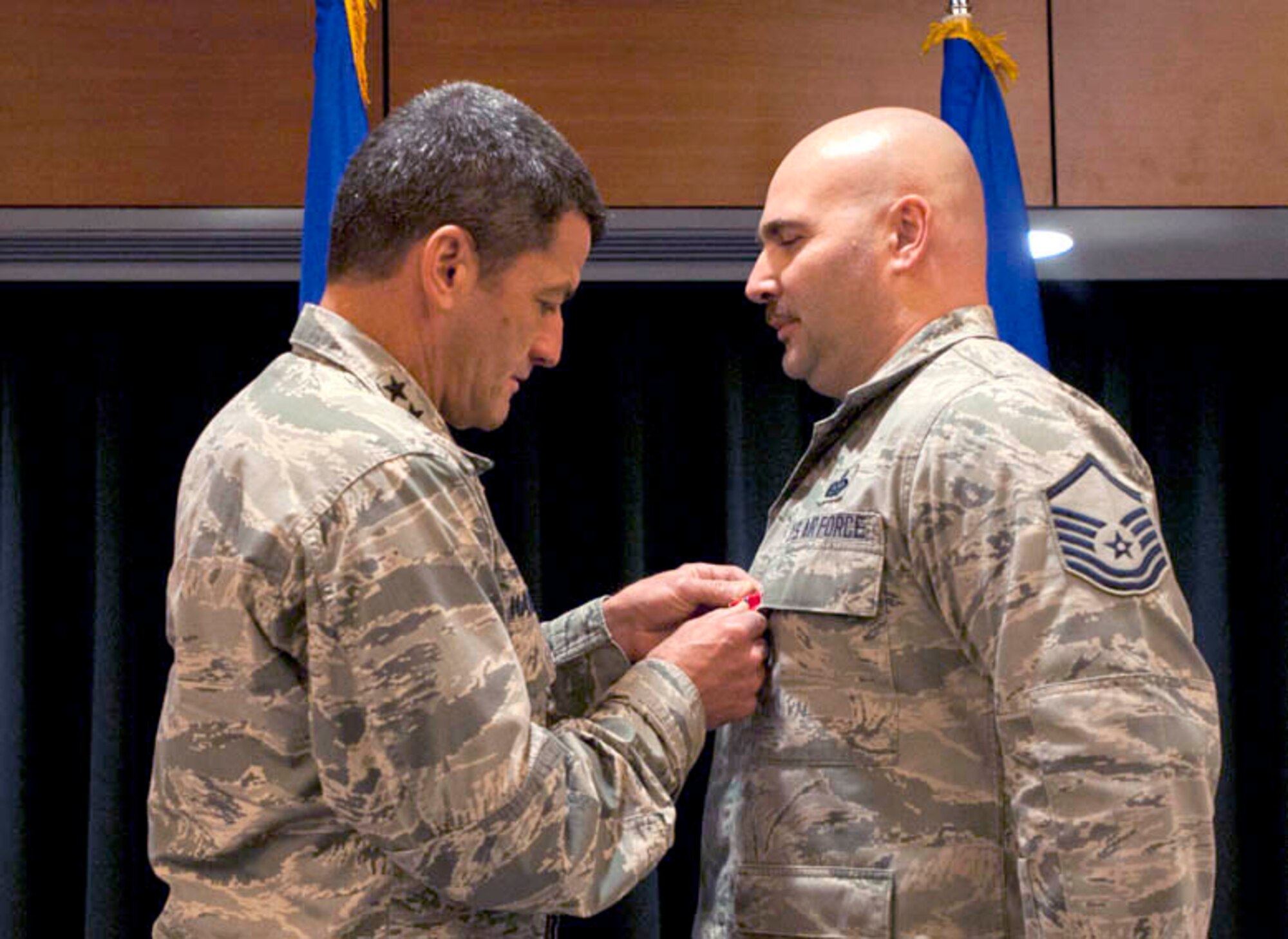 Air Force Master Sgt. Lee Pentimone receives a Bronze Star medal from Lt. Gen. Russell Handy at Joint Base Elmendorf-Richardson, Alaska, April 28. Pentimone earned the medal for his service during a year-long deployment in Afghanistan. (U.S. Air Force photo/Tech. Sgt. Robert Barnett)