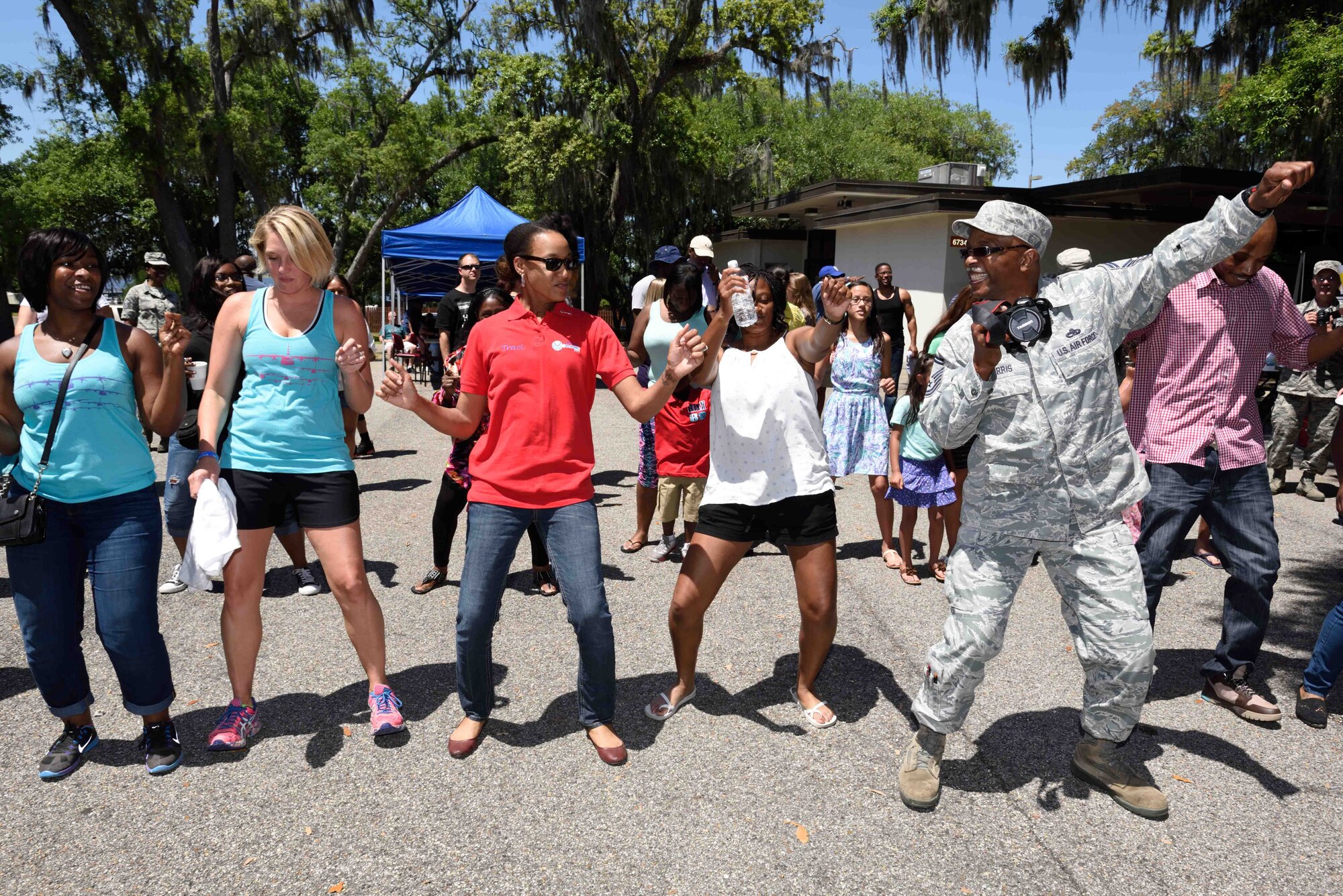 Members of the 403rd Wing line dance at the 403rd Wing Airman and Family Day May 2, 2015, at Keesler Air Force Base, Mississippi. (U.S. Air Force Photo/Tech. Sgt. Ryan Labadens)