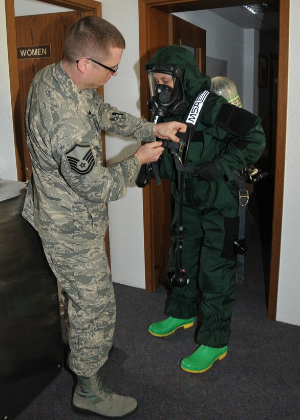 Master Sgt. Christopher McCrary, 104th Emergency Management Flight non-commissioned officer in charge, Barnes Air National Guard Base, Westfield, Mass., inspects the Personal Protection Level B suit on Tech. Sgt. Nicole Locke, 104th Emergency Management Flight, during an exercise May 6, 2015, Spangdahlem Air Base, Germany. McCrary and Locke are training on Active CBRNE (Chemical Biological Radiological Nuclear and High- Yield Explosives) Response with the active-duty members to enhance their Hazmat Technician Certification. This is a required training that needs to be done yearly by the guard and the active duty. Doing the training together allows them to increase their knowledge by sharing their experiences and use different types of equipment. (U.S. Air National Guard photo by 2nd Lt. Bonnie Harper /Released)