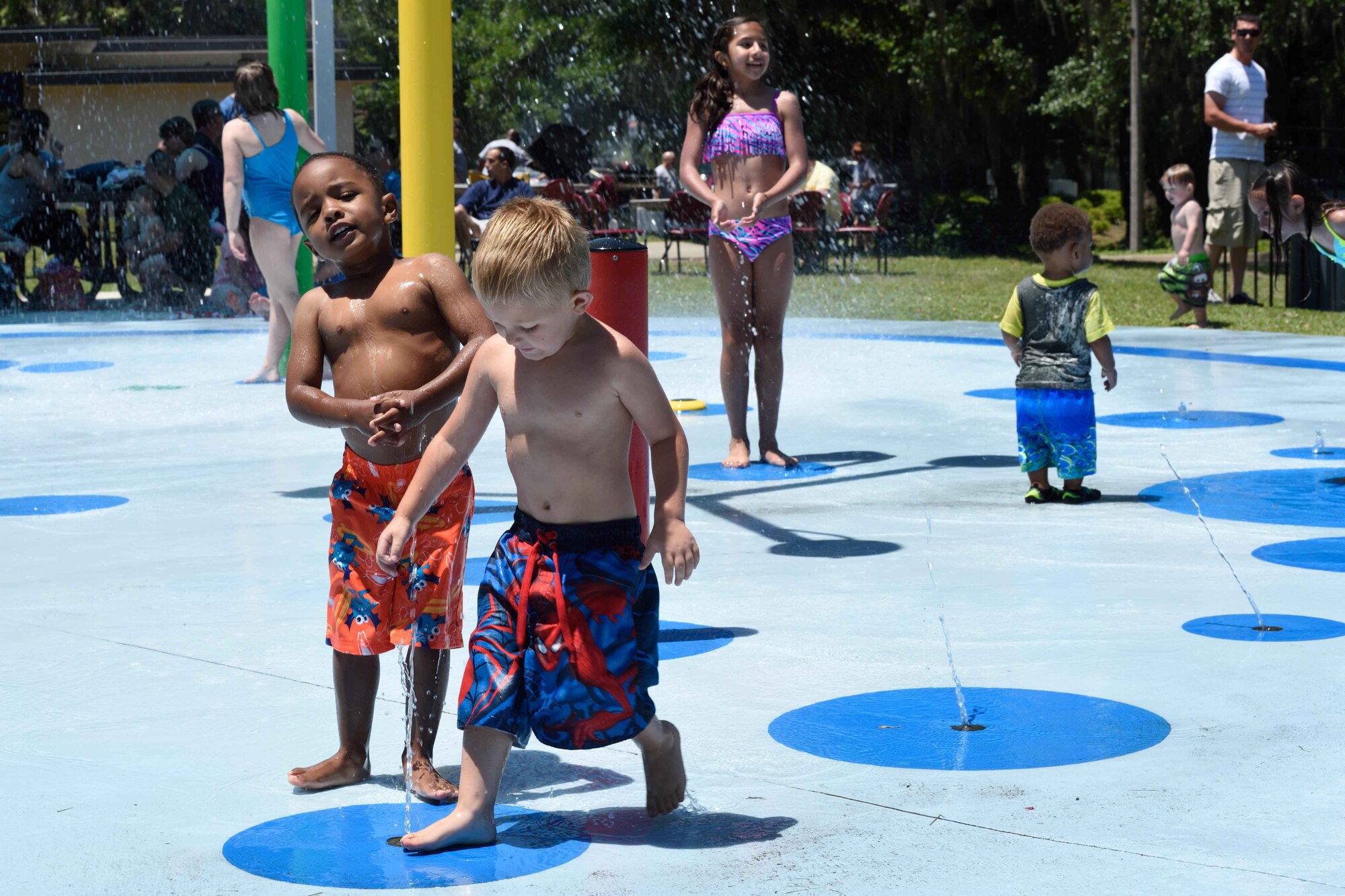 Young guests of 403rd Wing members play on the splash pad by the marina during the wing's 2015 Airman and Family Day event May 2, 2015, at Keesler Air Force Base, Mississippi. (U.S. Air Force Photo/Tech. Sgt. Ryan Labadens)