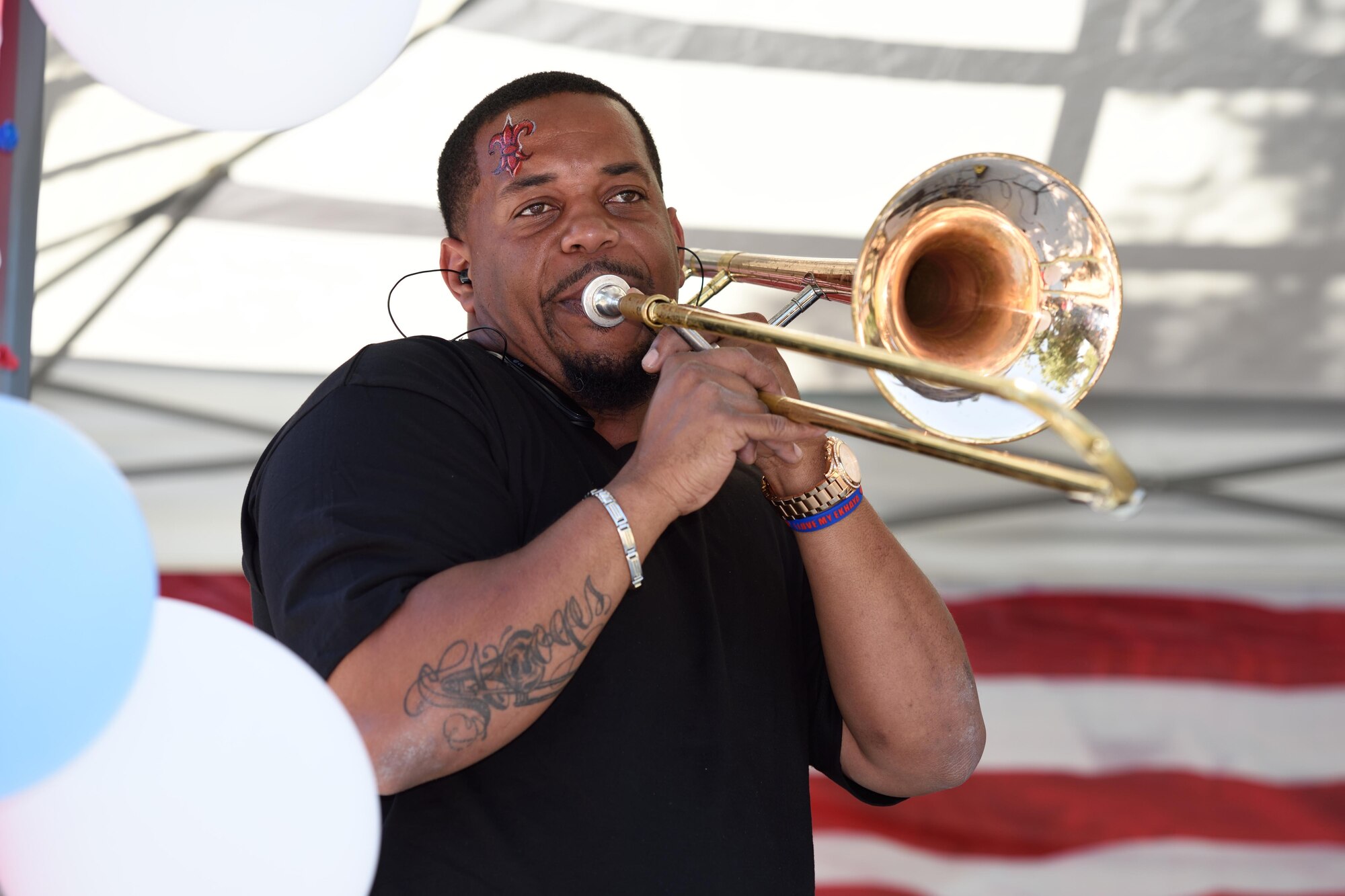 Ersel Bogan III, the spouse of Senior Airman Shea Bogan, a 403rd Wing financial management apprentice, performs on stage with the trombone during the 403rd Wing Airman and Family Day May 2, 2015, at Keesler Air Force Base, Mississippi.  (U.S. Air Force Photo/Tech. Sgt. Ryan Labadens)