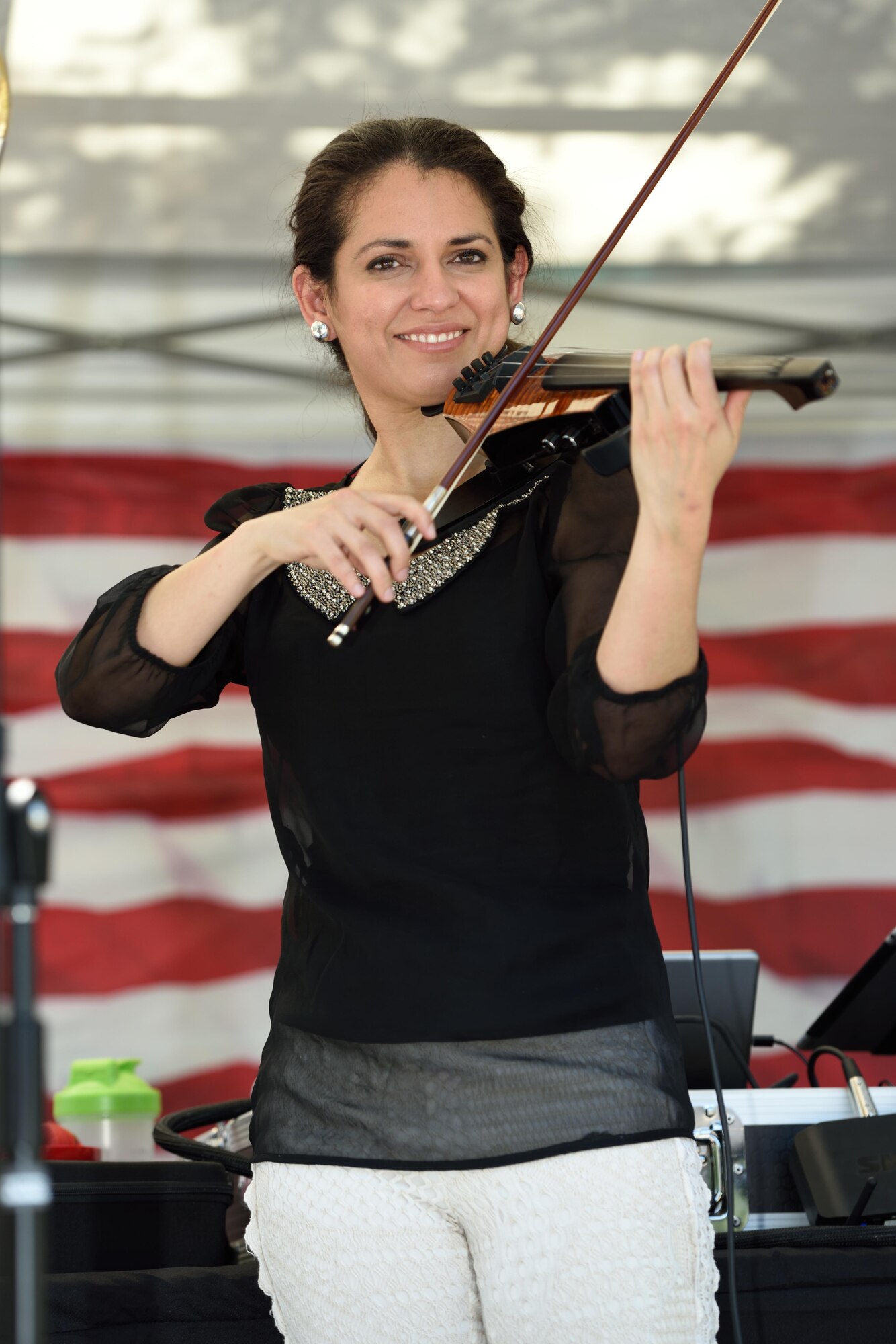 Senior Airman Kelly Andino, 403rd Operations Support Squadron/Intelligence intelligence analyst, performs on stage playing the violin during the 403rd Wing Airman and Family Day May 2, 2015, at Keesler Air Force Base, Mississippi. (U.S. Air Force Photo/Tech. Sgt. Ryan Labadens)