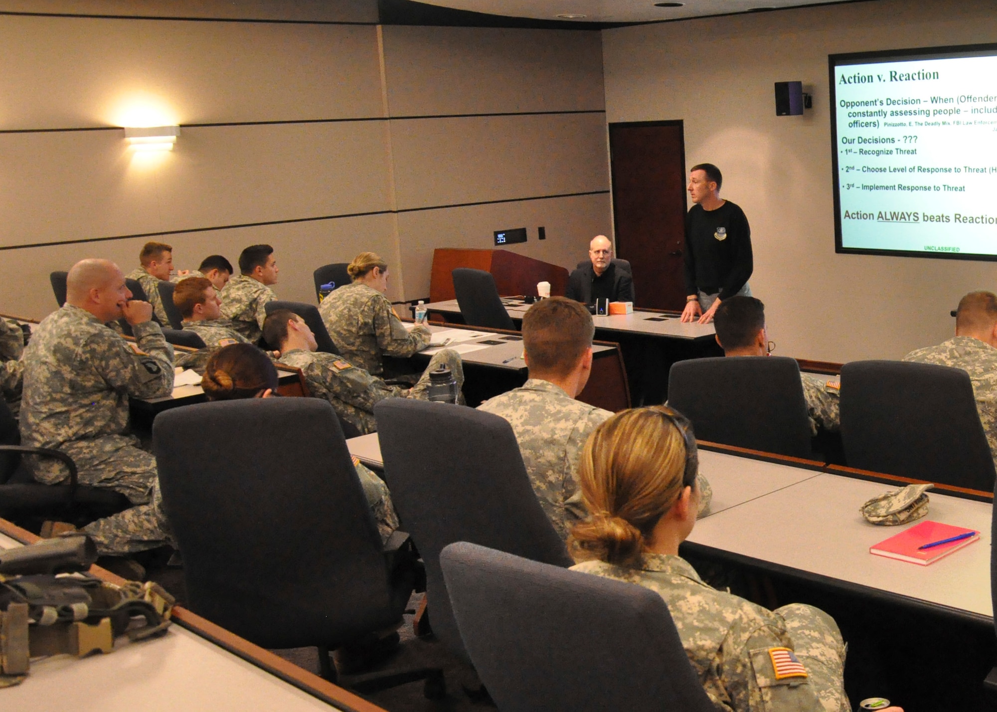 Maj. Ryan Hoback, 177th Fighter Wing deputy staff judge advocate, teaches a lesson on action and reaction during hostile moments to U.S. Military Academy Cadets May 2. The Cadets visited Joint Base McGuire-Dix-Lakehurst to take part in a two-day Judgment-based Engagement Training course provided by the U.S. Air Force Expeditionary Center Judge Advocate. The 18 West Point Cadets participated in classroom lectures, a Firearms Training Simulator, and action and reaction scenarios to practice making lawful decisions in real-time.(U.S. Air Force photo/Capt. Matthew Chism)