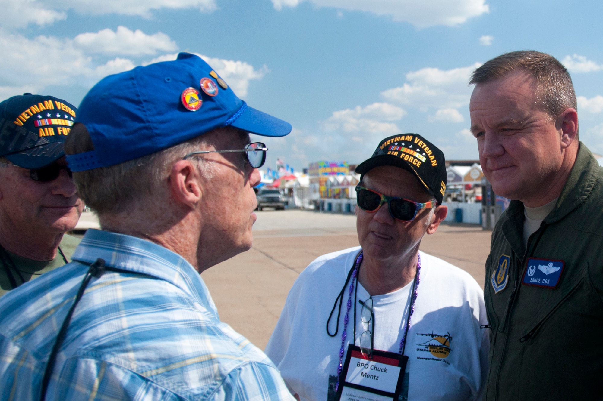 U.S. Air Force Col. Bruce Cox, 307th Bomb Wing commander, listens intently to Ken Curry during a reunion for 307th Bomb Wing Vietnam War veterans at Barksdale Air Force Base, La., May 1, 2015.  Curry, a former B-52 pilot, managed to save his jet after it took a hit from an enemy surface to air missile in 1972. He and other veterans served at U-Tapao Royal Thai Naval Airfield during the war.  (U.S. Air Force photo by Tech. Sgt. Ted Daigle/Released)