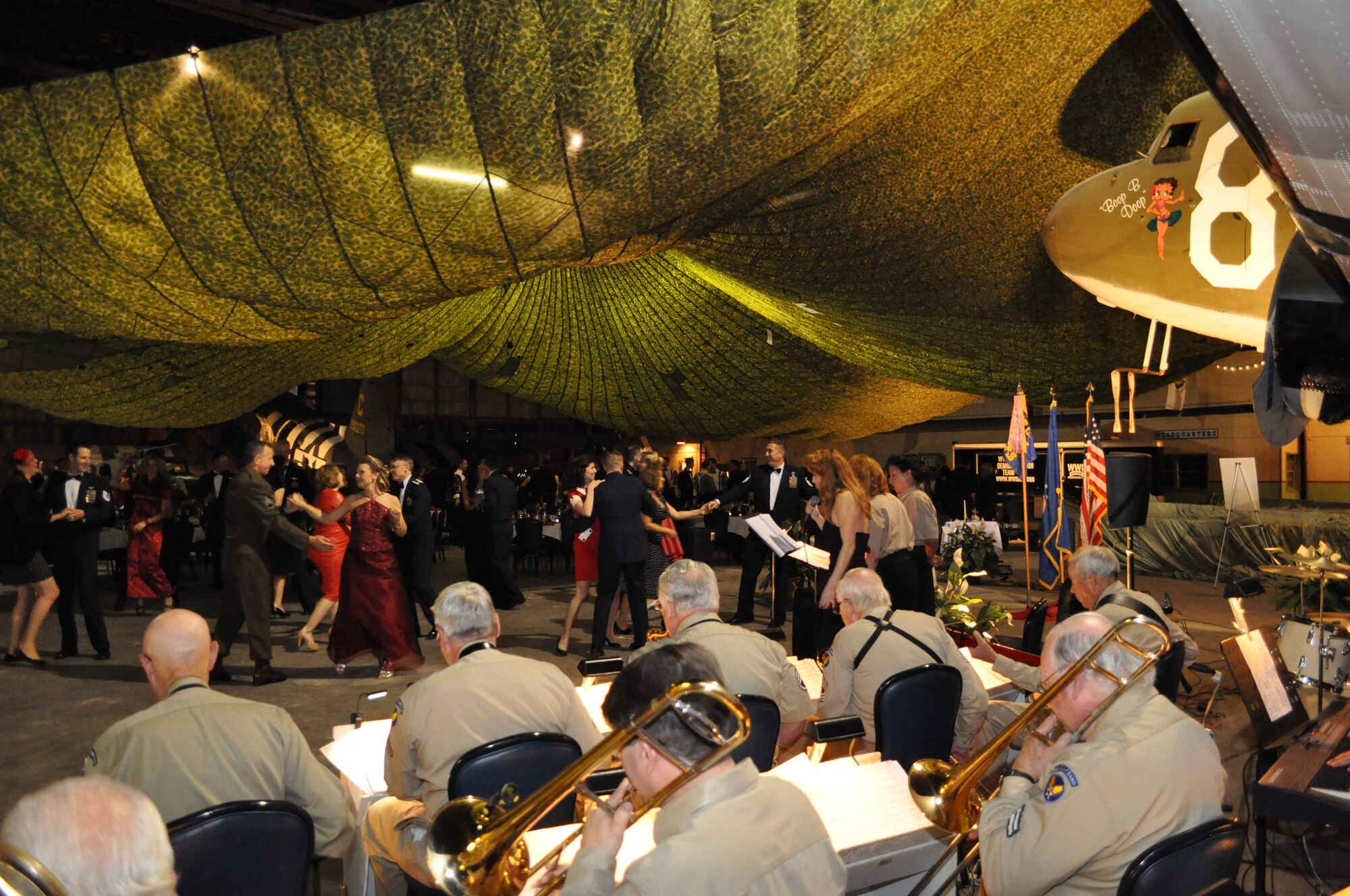 58th Airlift Squadron members, alumni, their guests and distinguished visitors, dance during a Heritage Dining Out at Frederick Army Airfield, April 18, 2015. The 58th Airlift Squadron hosted their inaugural Heritage Dining Out in collaboration with the World War II Airborne Demonstration Team at Frederick Army Airfield. (Courtesy Photo)