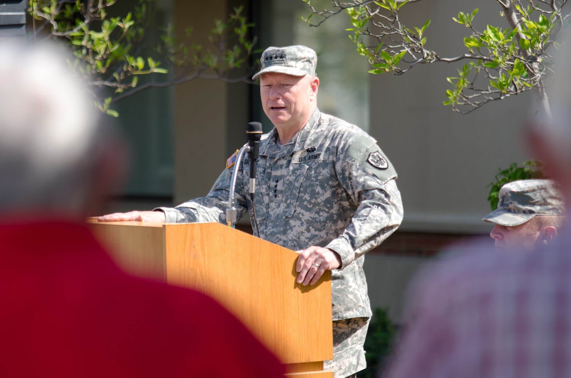 Army Gen. Frank J. Grass, chief of the National Guard Bureau, addresses a crowd of Airmen, friends and family during a ceremony honoring retirees from the 123rd Airlift Wing at the Kentucky Air National Guard Base in Louisville, Ky., April 18, 2015.  During the ceremony, a black granite plaque was unveiled that listed the names of more than 50 Airmen who retired during 2014. (U.S. Air National Guard photo by Senior Airman Joshua Horton)