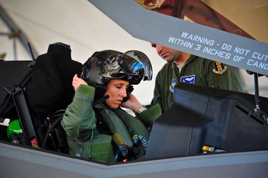 Lt. Col. Christine Mau, 33rd Operations Group deputy commander, puts on her helmet before taking her first flight in the F-35A on Eglin Air Force Base, Fla., May 5, 2015. Mau, who previously flew F-15E Strike Eagles, made history as the first female F-35 pilot in the program. (U.S. Air Force photo/Staff Sgt. Marleah Robertson)