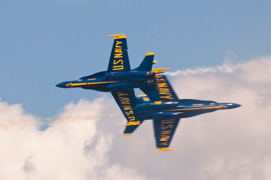 Members of the U.S. Navy Flight Demonstration Team Blue Angels perform the Opposing Knife Edge maneuver during the 2015 Defenders of Liberty Air Show at Barksdale Air Force Base, Louisiana, May 2. As the F/A-18 Hornets approach centerpoint, the pilots roll their aircraft into a 90 degree angle bank and push forward the stick, experiencing the sensation of weightlessness or ballistic flight, similar to that experienced by astronauts in space. (U.S. Air Force photo by Master Sgt. Jeff Walston)