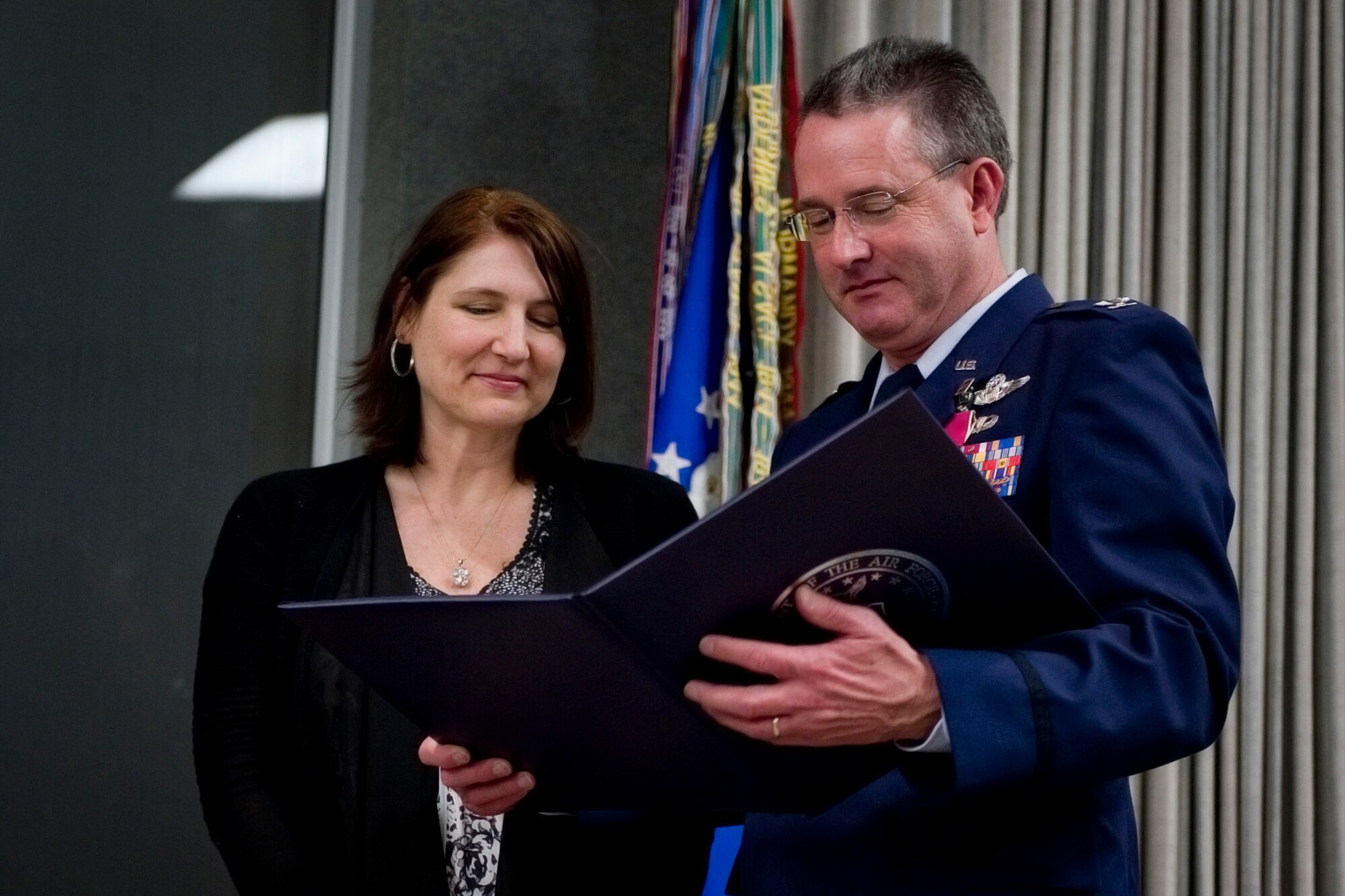 Col. Bryan Reinhart, 434th Air Refueling Wing vice commander, reads a certificate of appreciation to his wife, Tawnya Reinhart, during  his retirement ceremony at Grissom Air Reserve Base, Ind., April 11, 2015. Reinhart retired from the Air Force Reserve after more than 34 years of military service. (U.S. Air Force photo/Tech. Sgt. Benjamin Mota)