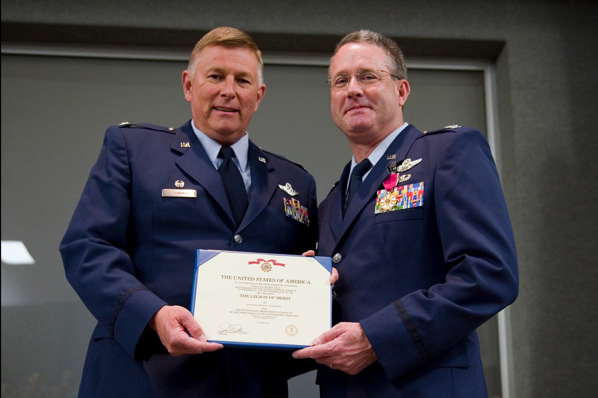 Col. Bryan Reinhart, 434th Air Refueling Wing vice commander, poses for a photo after receiving the Legion of Merit from Col. Douglas Schwartz, 434th Air Refueling Wing commander, during his retirement ceremony at Grissom Air Reserve Base, Ind., April 11, 2015. The Legion of Merit is conferred on officers and enlisted men of the armed forces of the United States and on nationals of other countries who shall have distinguished themselves by exceptionally meritorious conduct in the performance of outstanding services. (U.S. Air Force photo/Tech. Sgt. Benjamin Mota)