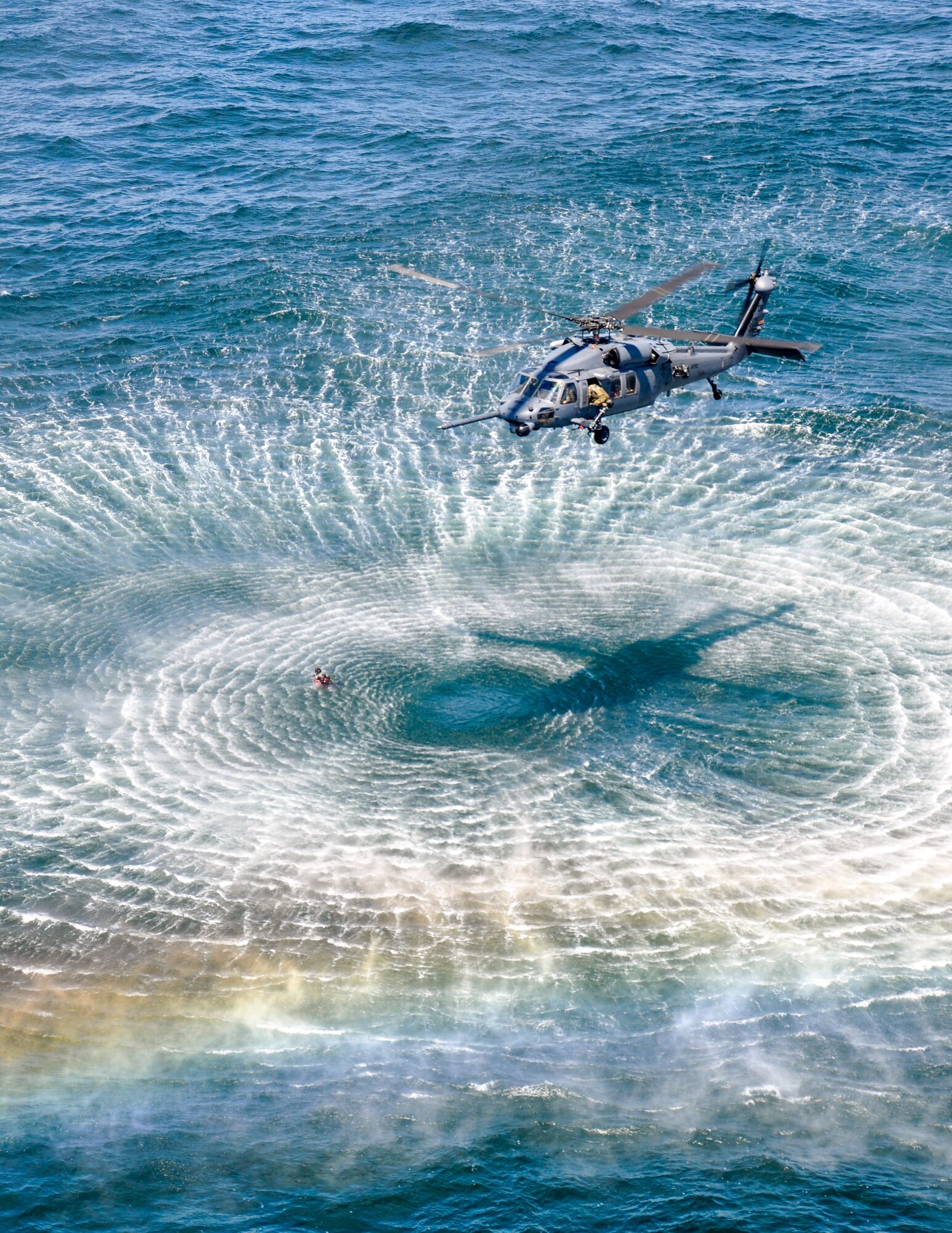 An HH-60 Pave Hawk helicopter from the 305th Rescue Squadron, Davis-Monthan Air Force Base, Ariz., hovers over a pararescueman in the Pacific Ocean near Oregon's northern coast May 5, 2015. The 305th RQS conducted water rescue training with PJs and combat rescue officers from the 304th RQS stationed at Portland Air National Guard Base, Ore. Both squadrons are geographically separated units of the 920th Rescue Wing, a combat search-and-rescue Air Force Reserve wing located at Patrick AFB, Fla. (U.S. Air Force photo by 2nd Lt. Anna-Marie Wyant)