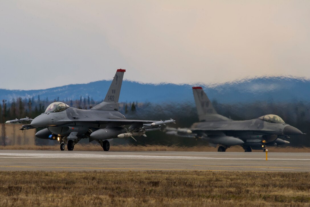 Two U.S. Air Force F-16 Fighting Falcons assigned to the 13th Fighter Squadron, Misawa Air Base, Japan, taxi on the Eielson Air Force Base, Alaska, flightline May 5, 2015, during RED FLAG-Alaska (RF-A) 15-2. RF-A is a series of Pacific Air Forces commander-directed field training exercises for U.S. and partner nation forces, providing combined offensive counter-air, interdiction, close air support and large force employment training in a simulated combat environment. (U.S. Air Force photo by Staff Sgt. Joshua Turner/Released)
