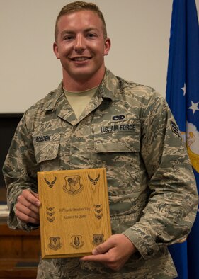 Senior Airman Kristopher Golden, 919th Special Operations Aircraft Maintenance Squadron, displays his plaque as second quarter outstanding Airman May 3 at Duke Field, Fla. Quarterly awards recognize individuals that exhibit high standards of performance through leadership and job performance, significant self-improvement, and base or community involvement.  (U.S. Air Force photo/Tech. Sgt. Cheryl Foster)
