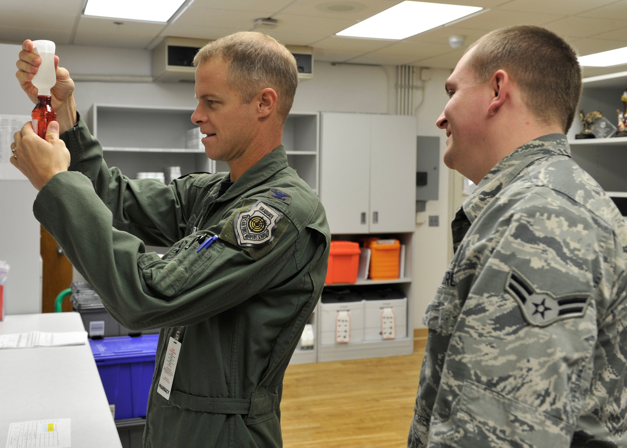 Airman 1st Class Cabretta Creamer, 325th Medical Group pharmacy technician, instructs Col. Derek C. France, 325th Fighter Wing commander, on how to mix different medications to create Magic Mouthwash May 1 at the Tyndall pharmacy. 325th MDG leadership selected Creamer to participate in the Airman Shadow Program. (U.S. Air Force photo by Airman 1st Class Sergio A. Gamboa/Released)

