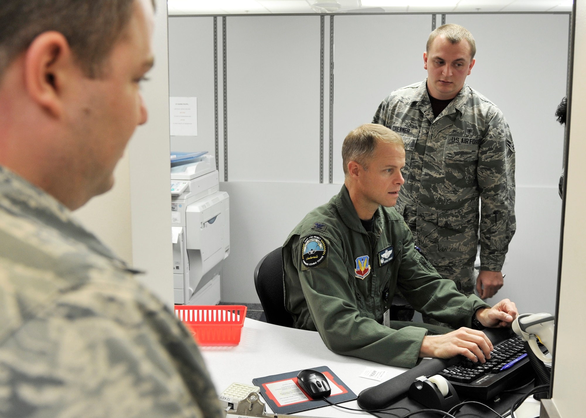 Airman 1st Class Cabretta Creamer, 325th Medical Group pharmacy technician, shows Col. Derek C. France, 325th Fighter Wing commander, how to operate the pharmacy customer service desk May 1 at the Tyndall pharmacy. 325th MDG leadership selected Creamer to participate in the Airman Shadow Program. (U.S. Air Force photo by Airman 1st Class Sergio A. Gamboa/Released)